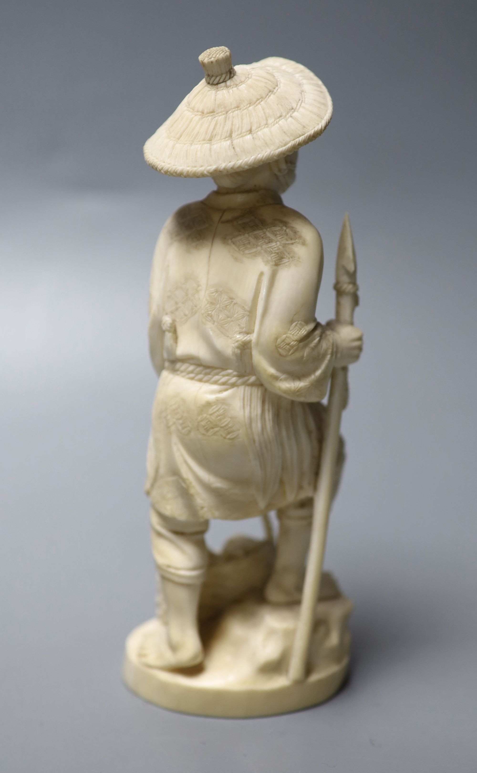 A Japanese Meiji period carved ivory figure of a fisherman, height 20cm